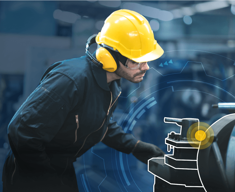 Man in a yellow hard hat looking at machinery